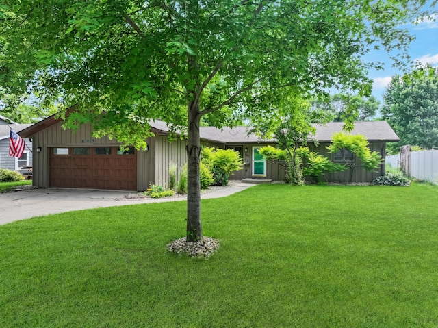 607 1st St, Marshall, MN 56258 - view of front facade with an attached garage, driveway, roof with shingles, and board and batten siding