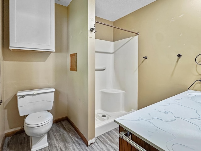 607 1st St, Marshall, MN 56258 - bathroom featuring wood finished floors, a shower stall, and vanity