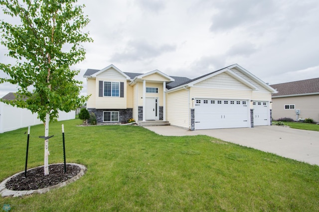 3661 Taylor St S, Fargo, ND 58104 - view of front of home with stone siding, a garage, and driveway