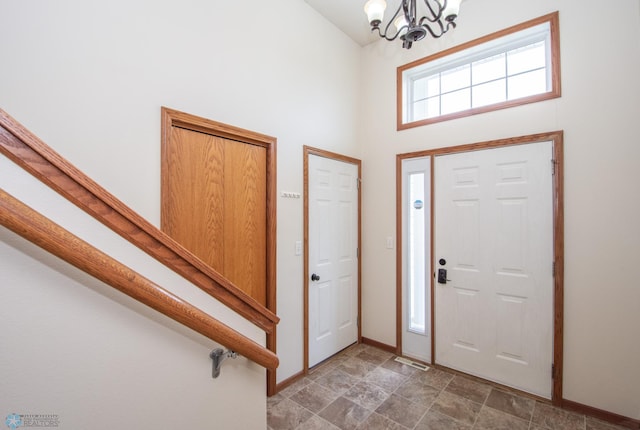 3661 Taylor St S, Fargo, ND 58104 - entrance foyer with a chandelier, a high ceiling, and stone finish floors