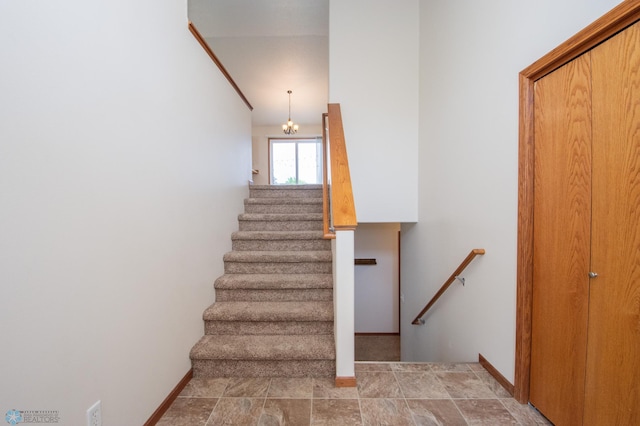 3661 Taylor St S, Fargo, ND 58104 - stairway with a chandelier and stone finish flooring