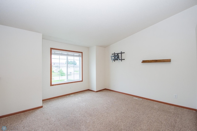 3661 Taylor St S, Fargo, ND 58104 - carpeted empty room with baseboards and lofted ceiling