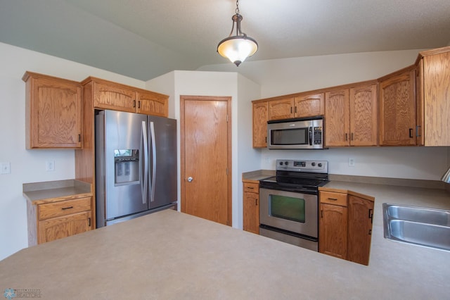 3661 Taylor St S, Fargo, ND 58104 - kitchen with stainless steel appliances, vaulted ceiling, hanging light fixtures, and light countertops