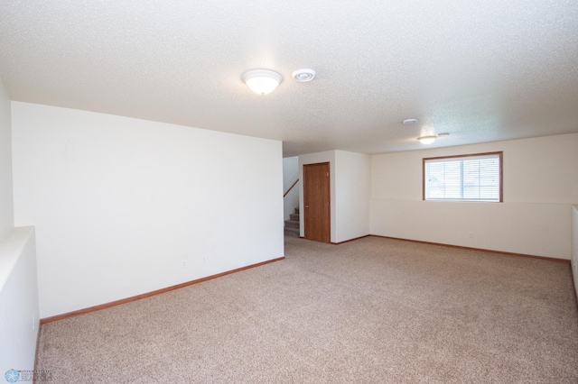 3661 Taylor St S, Fargo, ND 58104 - empty room featuring light colored carpet, a textured ceiling, and stairs