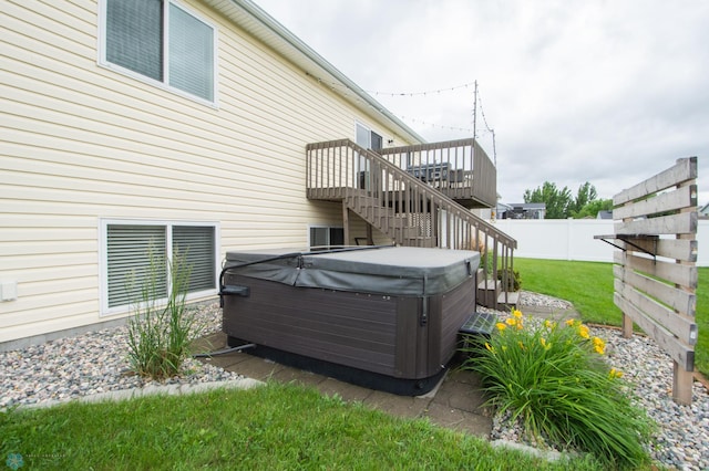 3661 Taylor St S, Fargo, ND 58104 - back of house with a hot tub, stairway, and a wooden deck