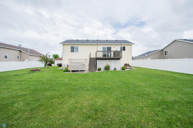 3661 Taylor St S, Fargo, ND 58104 - rear view of house with a fire pit, a wooden deck, stairway, and a fenced backyard