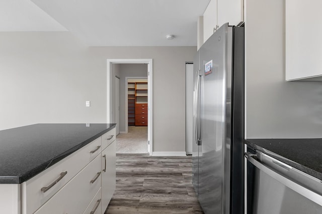 929 Portland Ave Unit 2106, Minneapolis, MN 55404 - kitchen featuring appliances with stainless steel finishes, dark countertops, white cabinets, and dark wood-style flooring