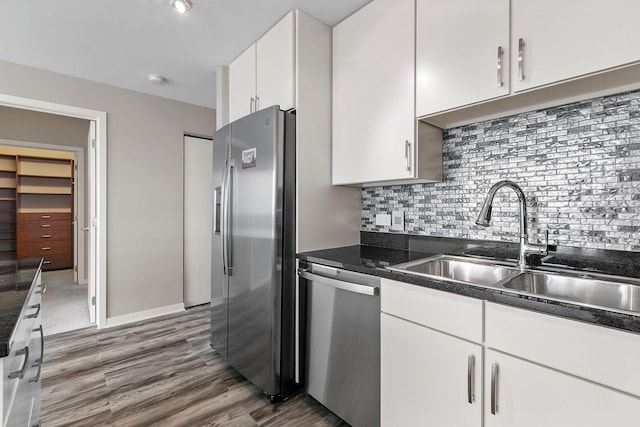 929 Portland Ave Unit 2106, Minneapolis, MN 55404 - kitchen featuring stainless steel appliances, wood finished floors, white cabinetry, and tasteful backsplash