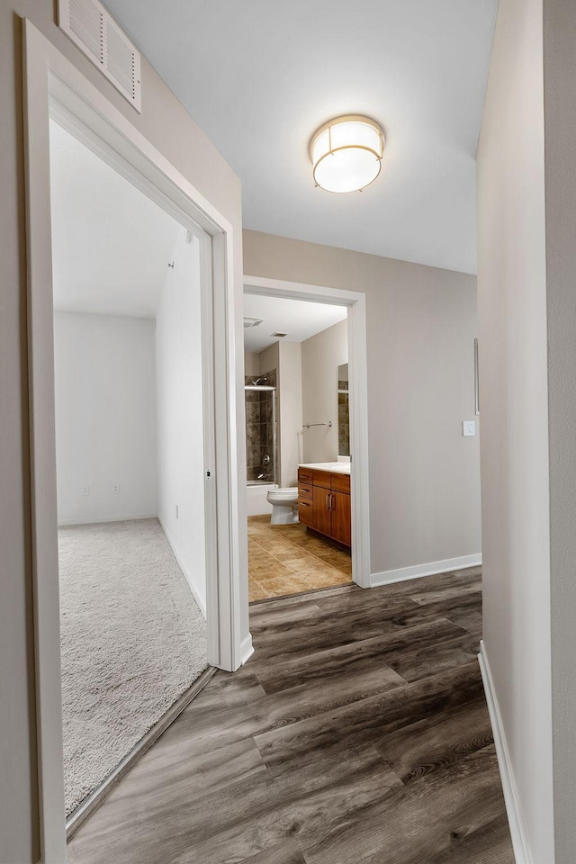 929 Portland Ave Unit 2106, Minneapolis, MN 55404 - hall featuring dark wood-style floors and baseboards