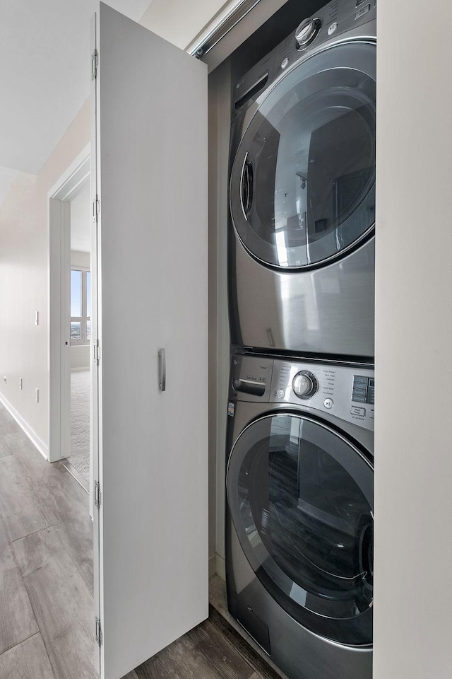 929 Portland Ave Unit 2106, Minneapolis, MN 55404 - laundry area with stacked washer and clothes dryer and wood finished floors