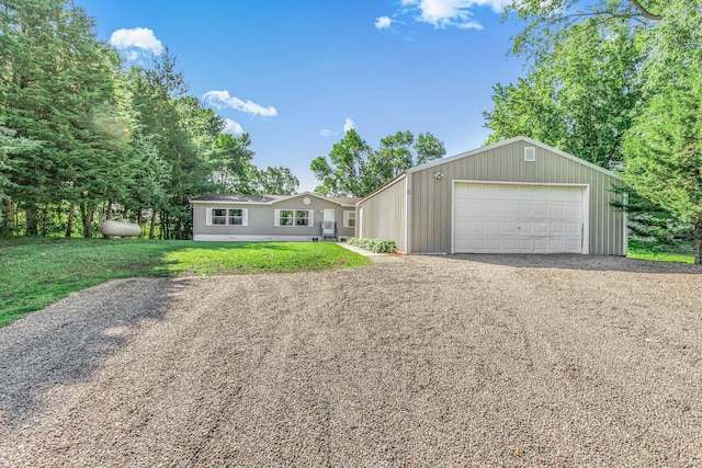57975 226th St, Litchfield, MN 55355 - view of front of property featuring a front lawn, gravel driveway, and a garage