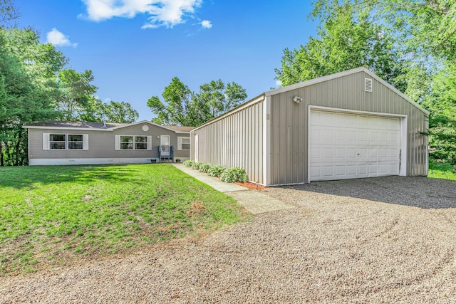 57975 226th St, Litchfield, MN 55355 - view of front of house with a detached garage, a front lawn, and gravel driveway