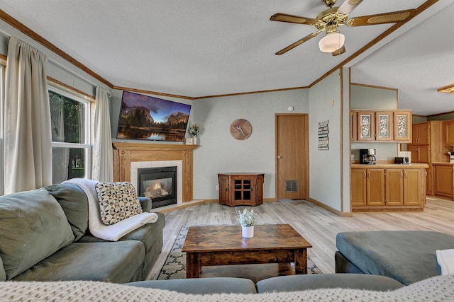 57975 226th St, Litchfield, MN 55355 - living area with crown molding, light wood finished floors, a textured ceiling, lofted ceiling, and ceiling fan