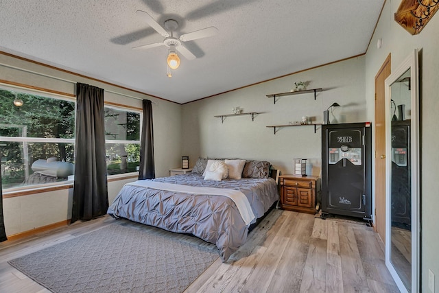 57975 226th St, Litchfield, MN 55355 - bedroom featuring wood finished floors, a textured ceiling, vaulted ceiling, a ceiling fan, and ornamental molding