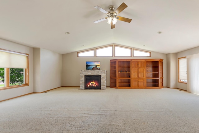 900 11th Ave SE, Waseca, MN 56093 - unfurnished living room featuring a fireplace with flush hearth, carpet floors, a ceiling fan, healthy amount of natural light, and lofted ceiling