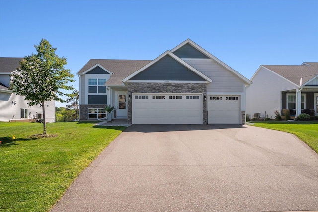 15005 Quintana St NW, Ramsey, MN 55303 - craftsman-style house with driveway, stone siding, a garage, and a front yard