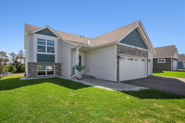 15005 Quintana St NW, Ramsey, MN 55303 - view of front of property featuring stone siding, an attached garage, asphalt driveway, and a front yard