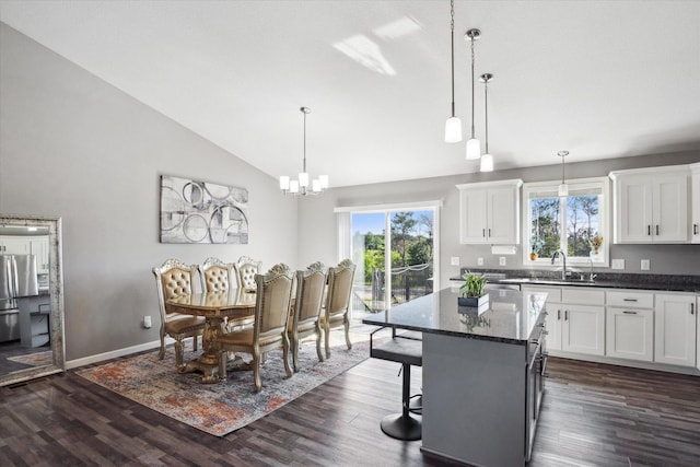 15005 Quintana St NW, Ramsey, MN 55303 - dining space with vaulted ceiling, dark wood-style flooring, and a chandelier