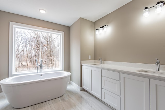 51440 Long Point Pl, Shamrock Twp, MN 55760 - bathroom with a soaking tub, healthy amount of natural light, double vanity, and marble look tiles