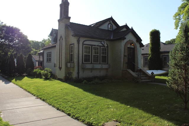 3660 45th Ave S, Minneapolis, MN 55406 - view of front of house with a front lawn, a chimney, and stucco siding