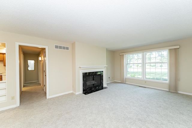 2051 Carriage Dr SW Unit 2051D, Rochester, MN 55902 - unfurnished living room featuring light carpet, a premium fireplace, and a textured ceiling