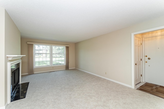 2051 Carriage Dr SW Unit 2051D, Rochester, MN 55902 - unfurnished living room featuring carpet, a fireplace, and a textured ceiling