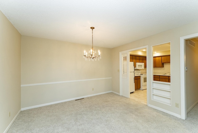 2051 Carriage Dr SW Unit 2051D, Rochester, MN 55902 - unfurnished room with light carpet and a chandelier