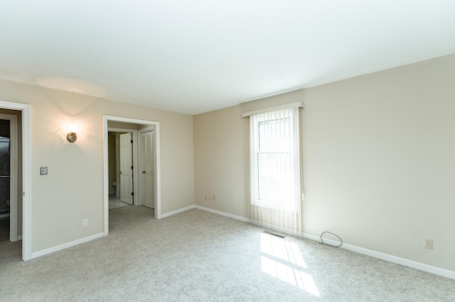 2051 Carriage Dr SW Unit 2051D, Rochester, MN 55902 - carpeted spare room featuring baseboards