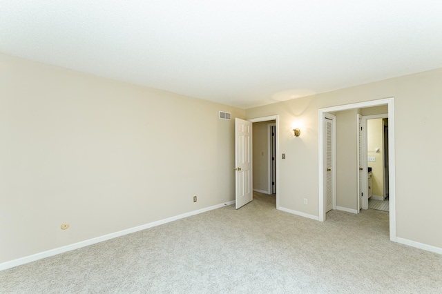 2051 Carriage Dr SW Unit 2051D, Rochester, MN 55902 - unfurnished bedroom featuring light carpet and baseboards