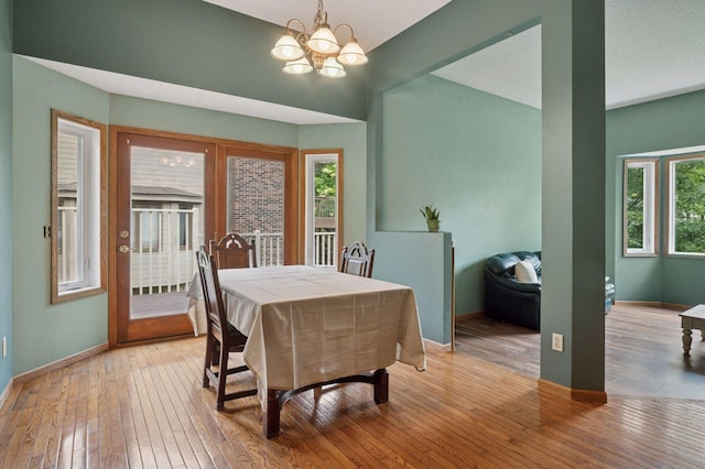 10989 Eagle Lake Blvd, Maple Grove, MN 55369 - dining space featuring a chandelier, light wood-style flooring, and healthy amount of natural light