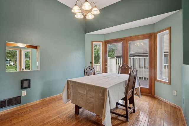 10989 Eagle Lake Blvd, Maple Grove, MN 55369 - dining area with a chandelier, light wood-type flooring, plenty of natural light, and high vaulted ceiling