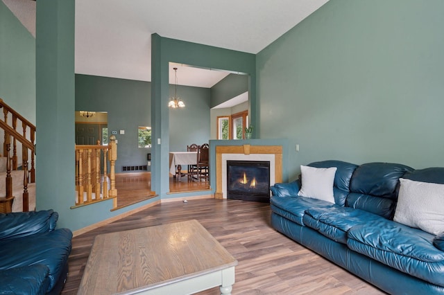 10989 Eagle Lake Blvd, Maple Grove, MN 55369 - living area with a chandelier, wood finished floors, stairs, and a glass covered fireplace