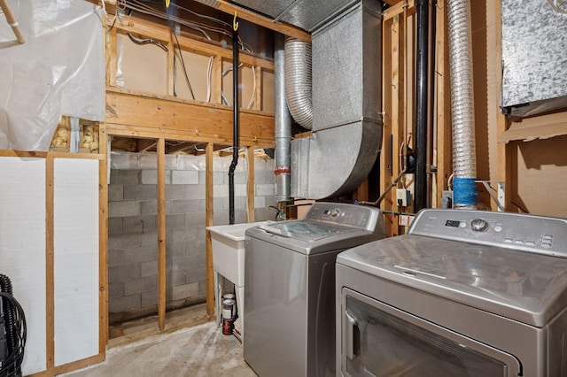 10989 Eagle Lake Blvd, Maple Grove, MN 55369 - laundry room with washing machine and clothes dryer and concrete block wall