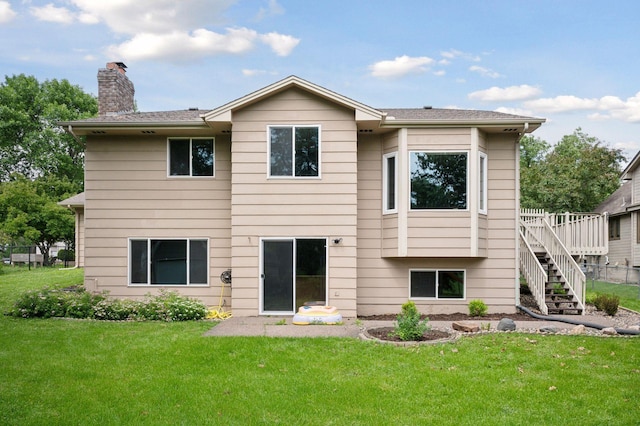 10989 Eagle Lake Blvd, Maple Grove, MN 55369 - rear view of house with a chimney, a yard, and stairway