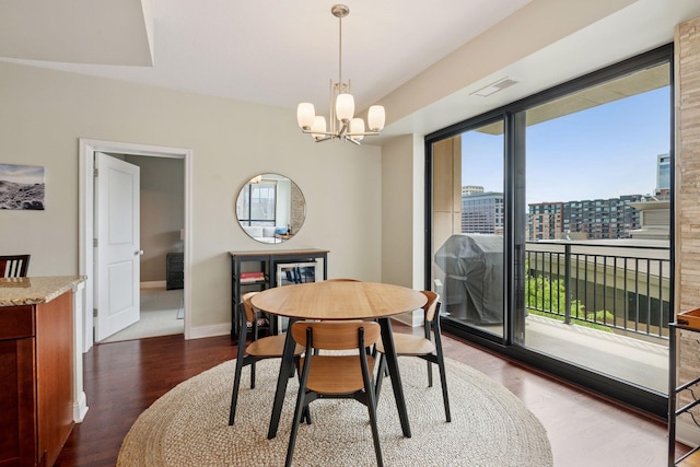 100 3rd Ave S Unit 706, Minneapolis, MN 55401 - dining space featuring dark wood-style flooring, a chandelier, and a city view