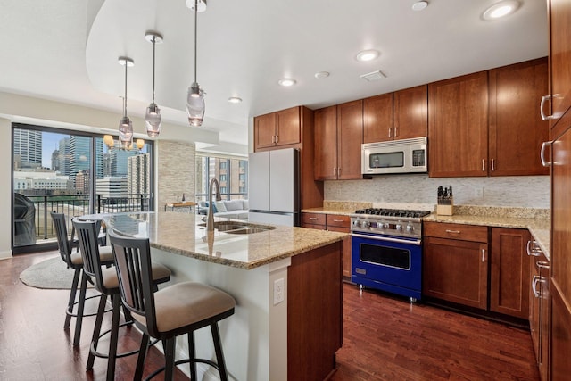 100 3rd Ave S Unit 706, Minneapolis, MN 55401 - kitchen featuring stainless steel microwave, freestanding refrigerator, premium stove, tasteful backsplash, and dark wood-type flooring