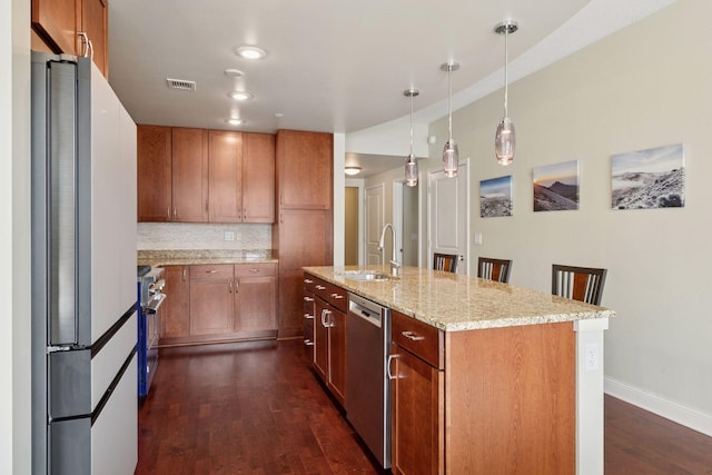 100 3rd Ave S Unit 706, Minneapolis, MN 55401 - kitchen with appliances with stainless steel finishes, dark wood finished floors, decorative backsplash, hanging light fixtures, and light stone counters