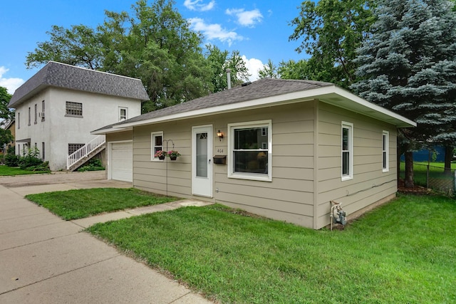 404 2nd St W, Jordan, MN 55352 - bungalow featuring concrete driveway, a garage, and roof with shingles