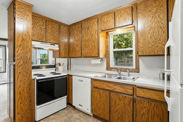 404 2nd St W, Jordan, MN 55352 - kitchen with white appliances, under cabinet range hood, light countertops, a textured ceiling, and brown cabinets