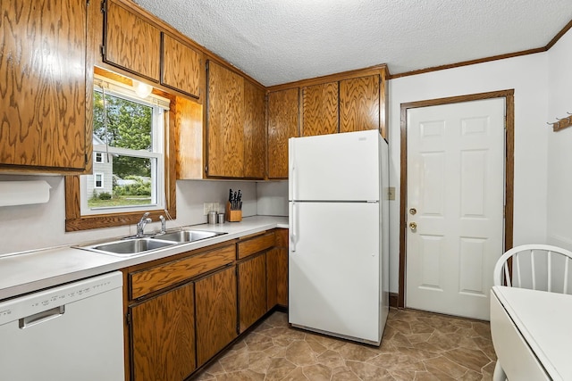 404 2nd St W, Jordan, MN 55352 - kitchen featuring white appliances, brown cabinetry, light countertops, a textured ceiling, and ornamental molding