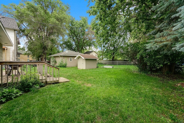 404 2nd St W, Jordan, MN 55352 - fenced backyard with a storage unit and a deck