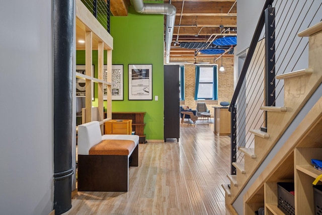 406 Wacouta St Unit 207, Saint Paul, MN 55101 - interior space featuring stairway, wood finished floors, and brick wall