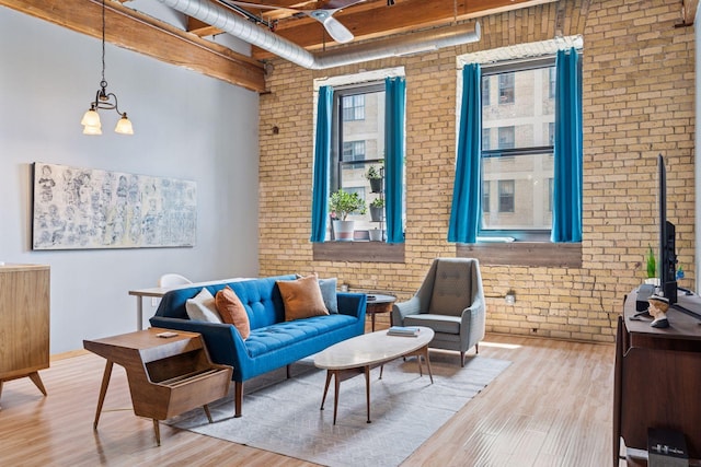 406 Wacouta St Unit 207, Saint Paul, MN 55101 - living room featuring brick wall, wood finished floors, and a ceiling fan