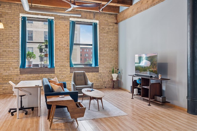 406 Wacouta St Unit 207, Saint Paul, MN 55101 - sitting room with brick wall, wood finished floors, and beam ceiling