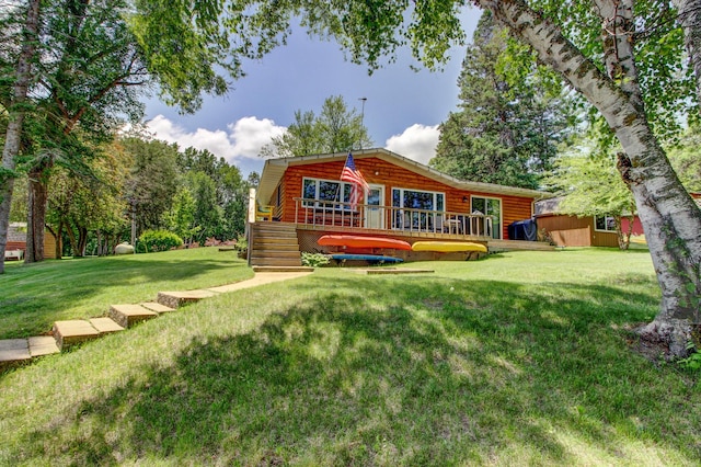 37566 Tulaby Lake Dr, Waubun, MN 56589 - rear view of property with a deck, a yard, and log veneer siding