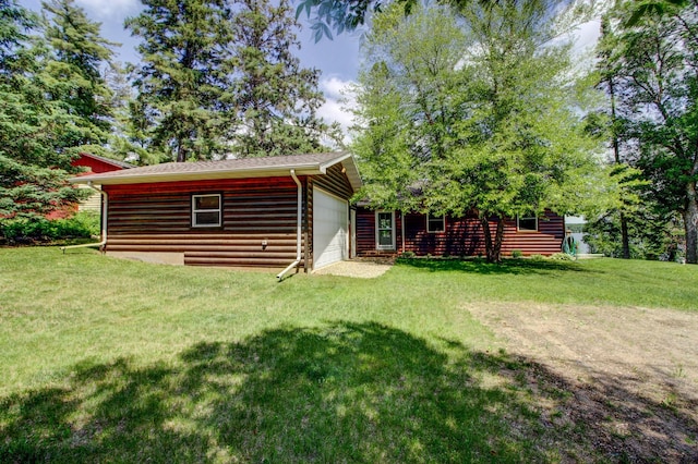 37566 Tulaby Lake Dr, Waubun, MN 56589 - rear view of house featuring an attached garage, a yard, and faux log siding