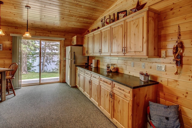 37566 Tulaby Lake Dr, Waubun, MN 56589 - kitchen featuring freestanding refrigerator, wooden walls, lofted ceiling, dark countertops, and wood ceiling