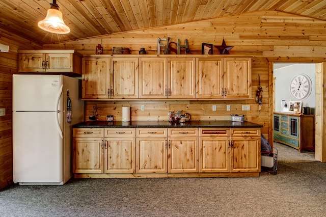 37566 Tulaby Lake Dr, Waubun, MN 56589 - kitchen featuring freestanding refrigerator, lofted ceiling, wood walls, dark colored carpet, and dark countertops