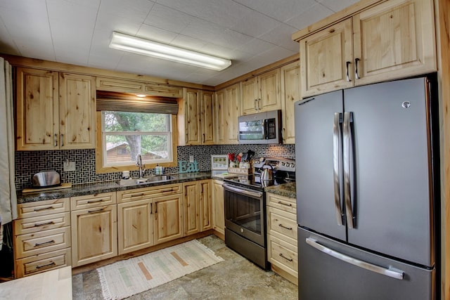37566 Tulaby Lake Dr, Waubun, MN 56589 - kitchen with appliances with stainless steel finishes, light brown cabinetry, backsplash, and dark stone counters