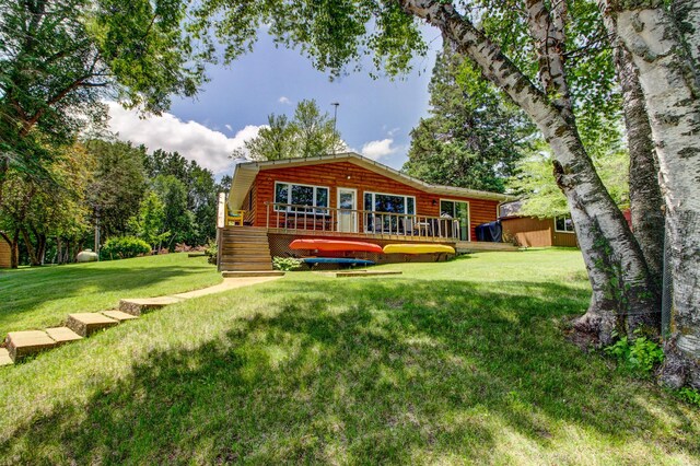 37566 Tulaby Lake Dr, Waubun, MN 56589 - view of front of property with a deck, a front lawn, and log veneer siding